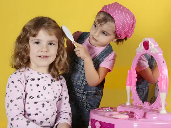 A girl is putting makeup on another girl