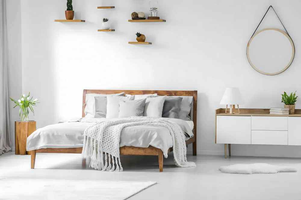 There is a mirror hanging in the bedroom