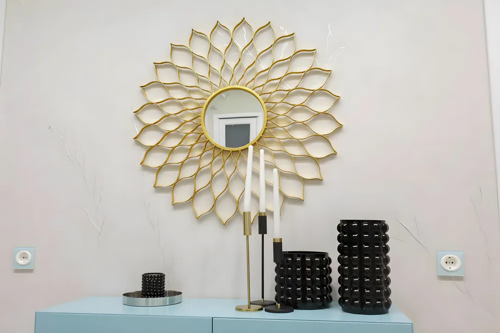 A decorative mirror hangs on the table at home