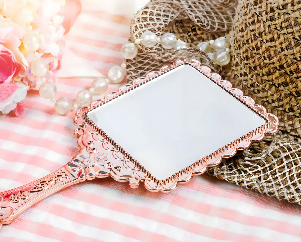 A handheld mirror produced by a certain brand