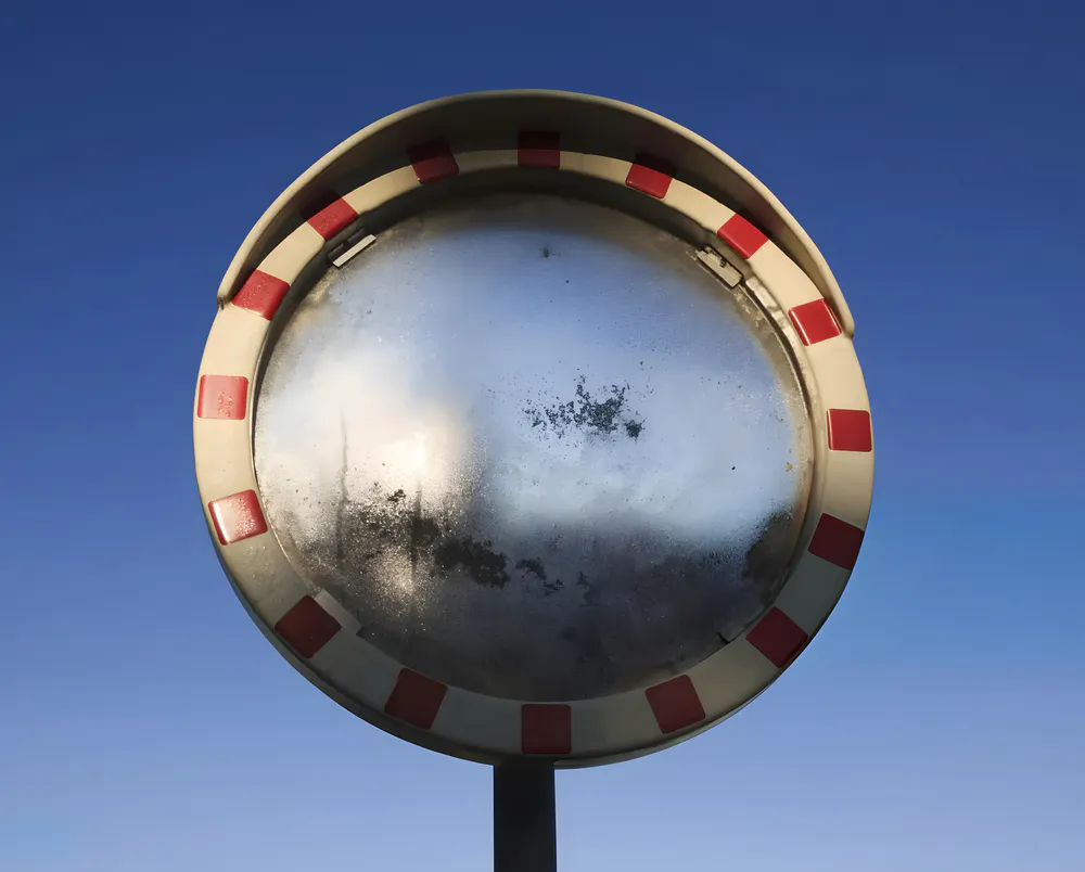 A traffic mirror that has rusted