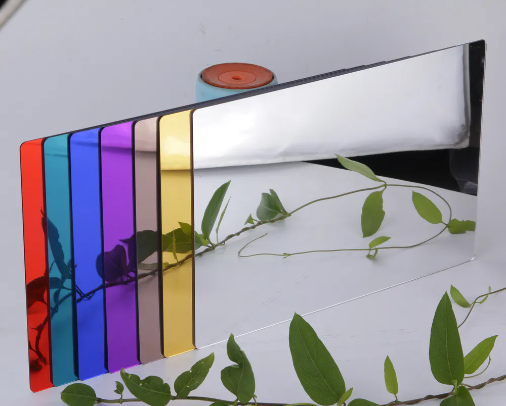 Seven colored plastic mirrors are arranged horizontally and reflect the tree branches