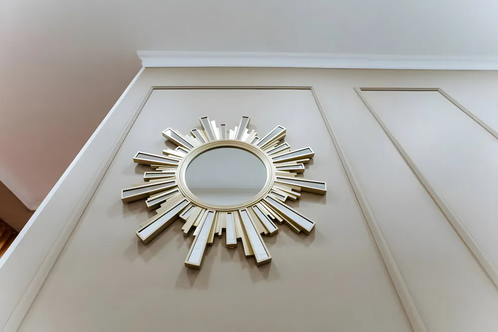 a sun-shaped decorative mirror on the counter in the hotel room