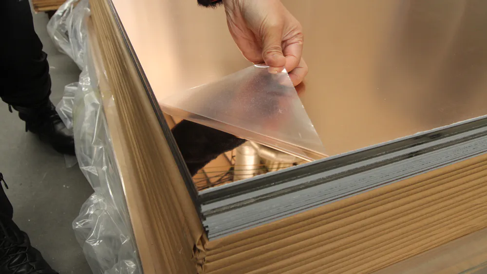 Lift a corner of the thin film on the gold large mirror sheet to check the effect
