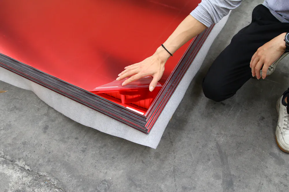 Lift a corner of the thin film on the red large mirror sheet to check the effect
