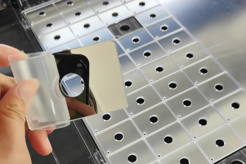 Pick up a small laser‑cut lens and photograph it