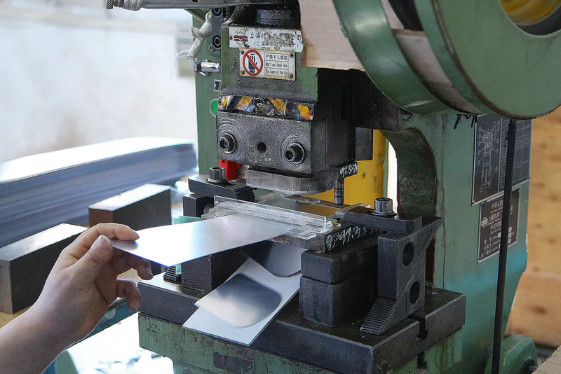 Thin mirror sheet are stamped using a stamping machine
