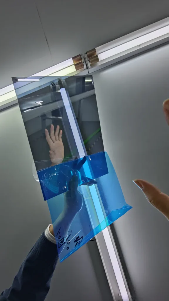 Remove the protective films from both sides of the two‑way mirror before shooting