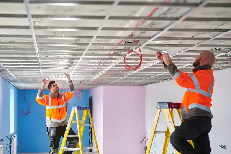 The workers are preparing for the ceiling installation