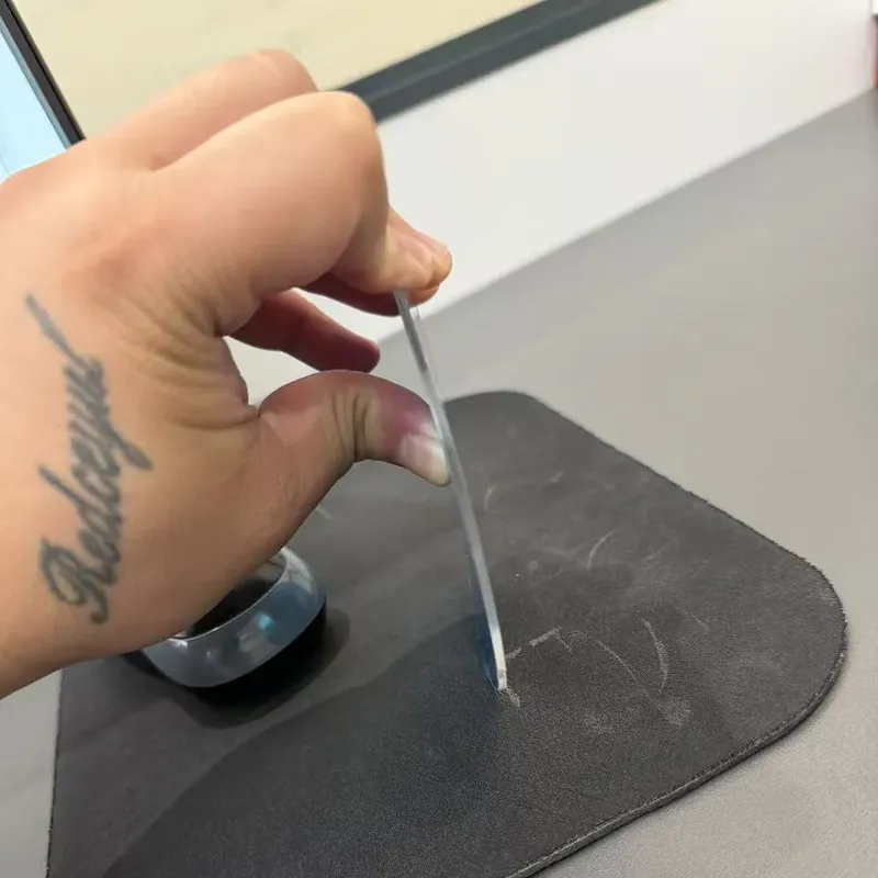 Try pressing firmly on the acrylic mirror
