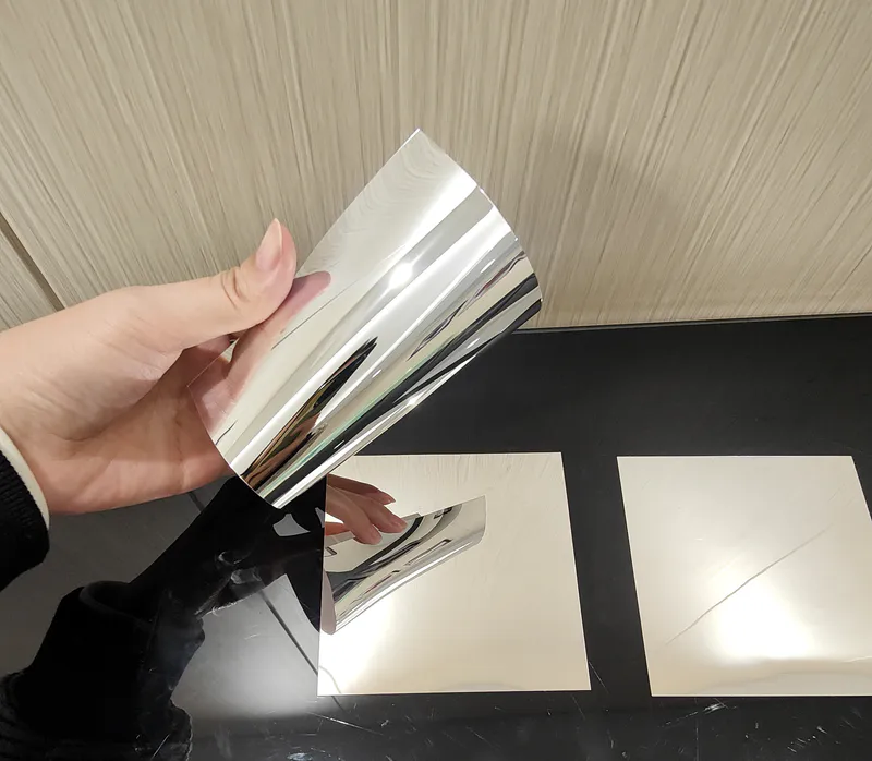 A highly flexible mirror is squeezed and bent in the hand.