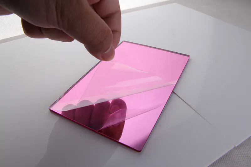 Tear open a corner of the protective film on the pink acrylic mirror