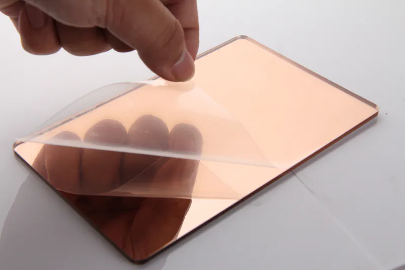 Tear open a corner of the protective film on the rose gold acrylic mirror