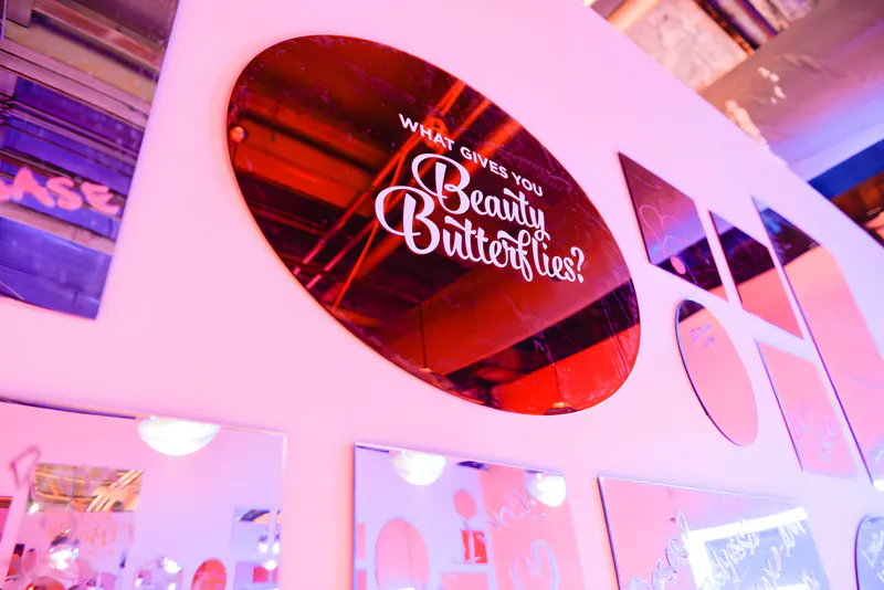Red acrylic mirror sign on the wall