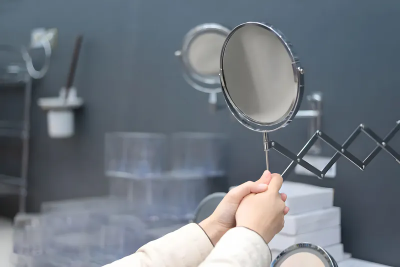 A common retractable acrylic mirror in the bathroom
