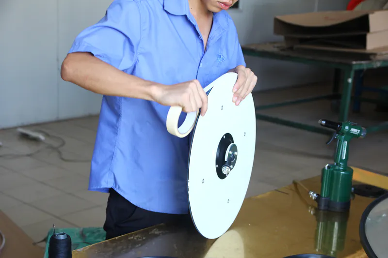 Our workers are sealing the acrylic convex mirror and the protective layer on the back