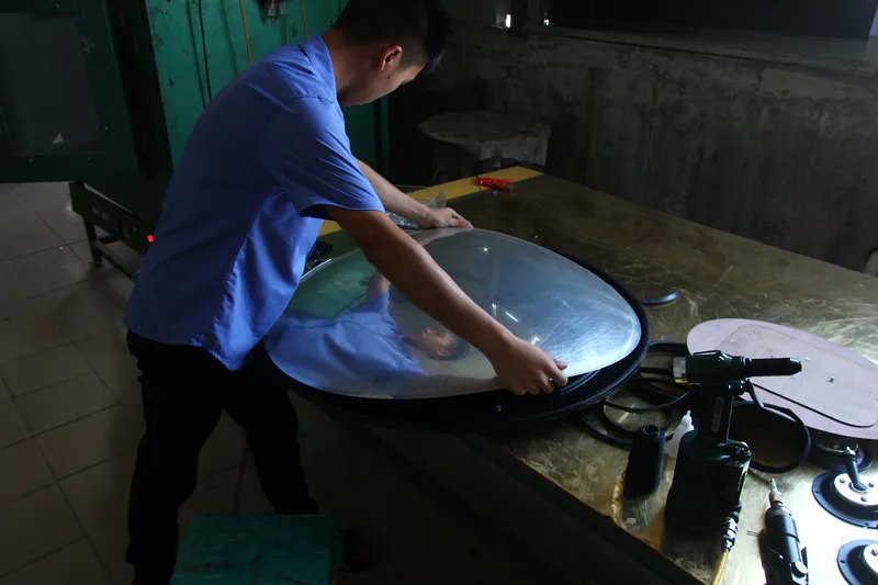 Workers are installing the back panels and accessories onto the convex mirrors as usual